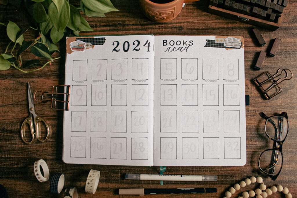 A reading journal spread of all the books I read in 2024, including book cover images and star rating.