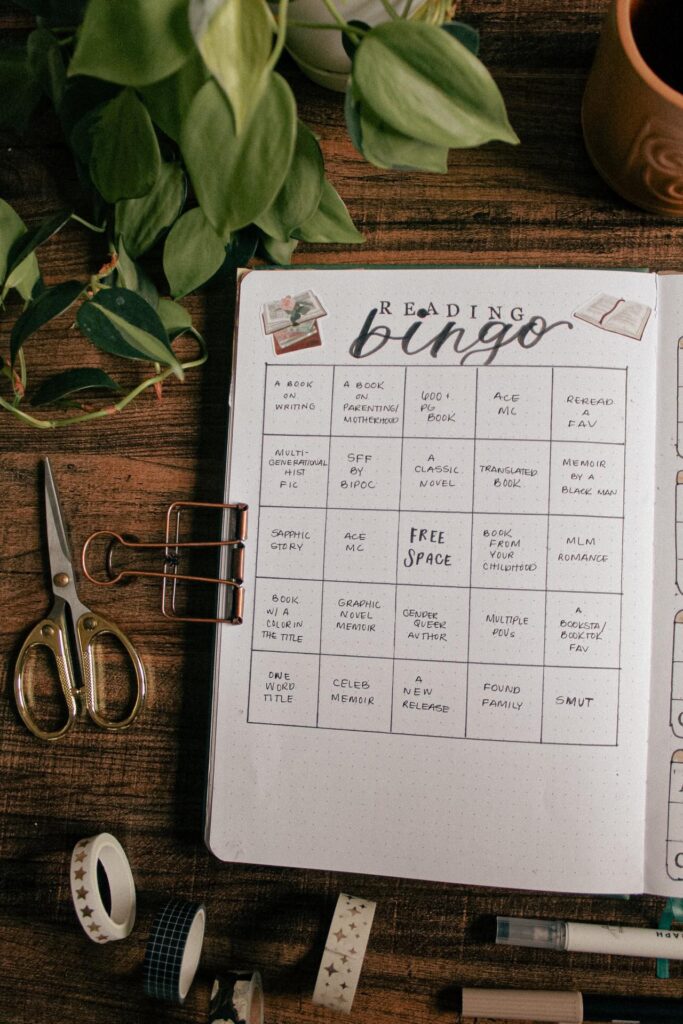 A reading bingo spread in my reading journal. A 5x5 square with different reading challenge prompts to complete and a free space in the middle.