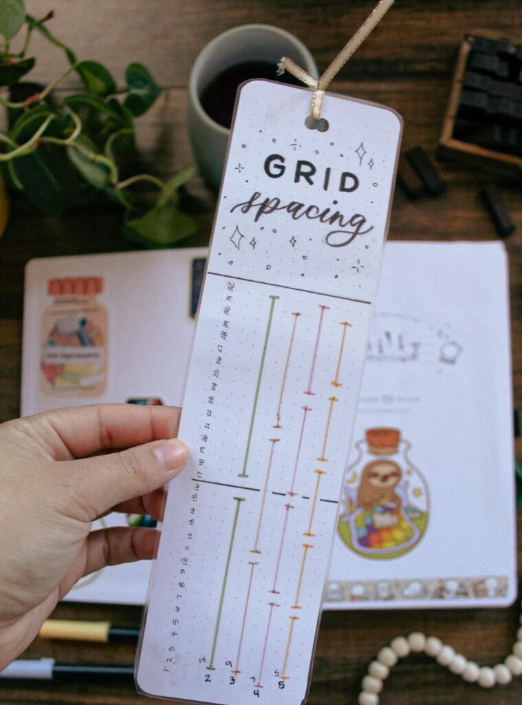 A grid spacing bookmark used to mark out layouts in bullet journal spreads.